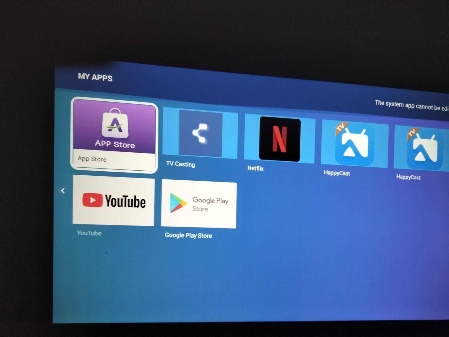 Projection smart phone screen displaying app store, Netflix, YouTube and Google Play apps on a blue background