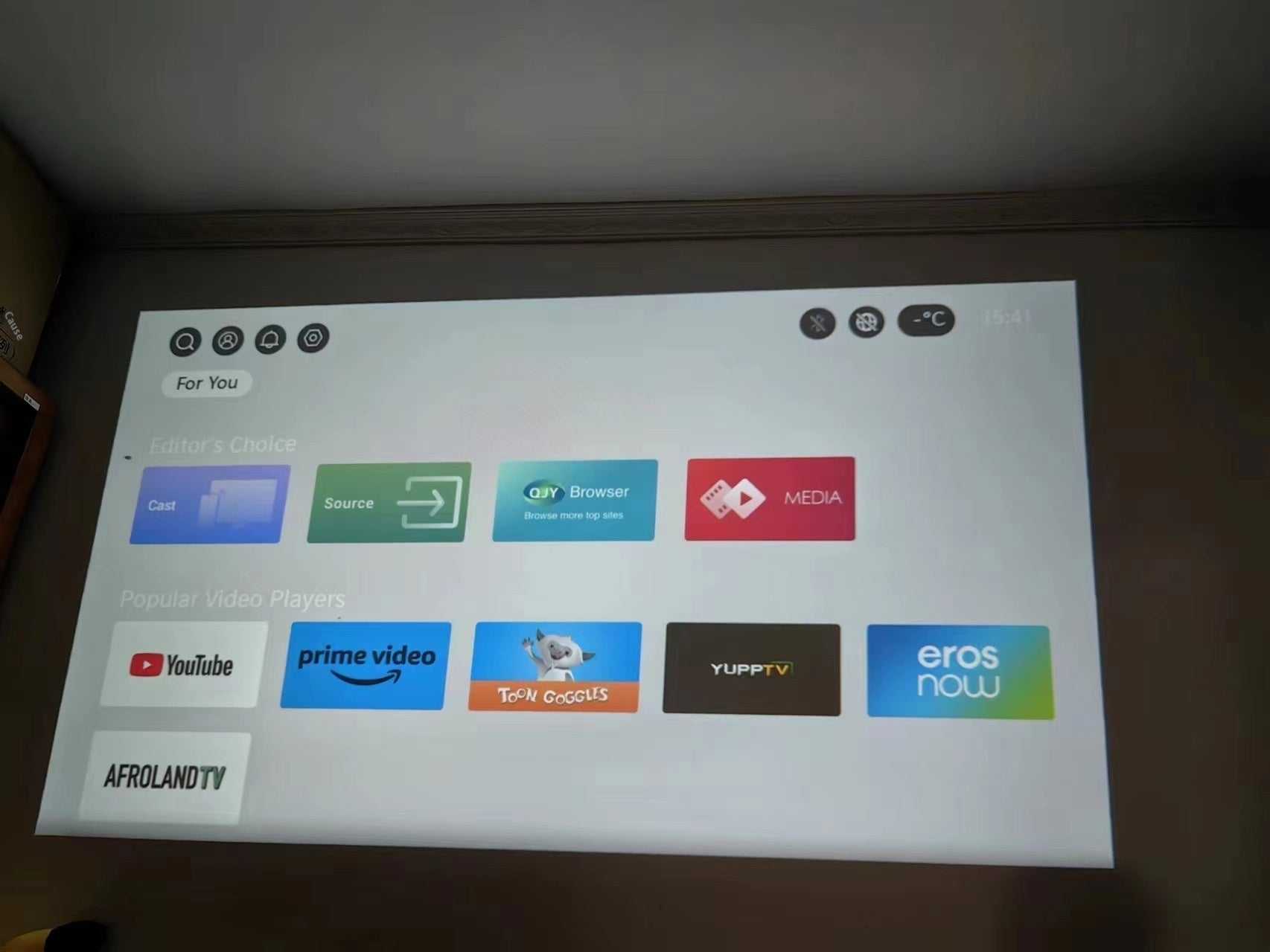 Portable miniature projection smart phone screen displaying streaming app interface on wall in 1080p quality