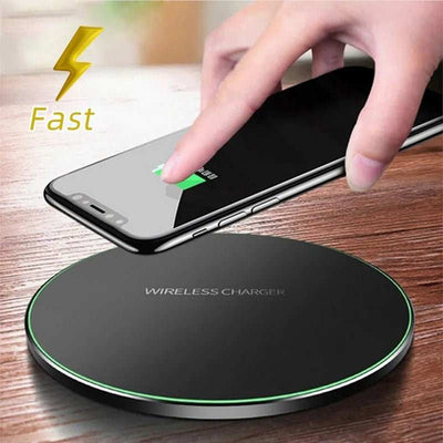 Wireless fast charger with sleek black design and green LED light charging a smartphone wirelessly